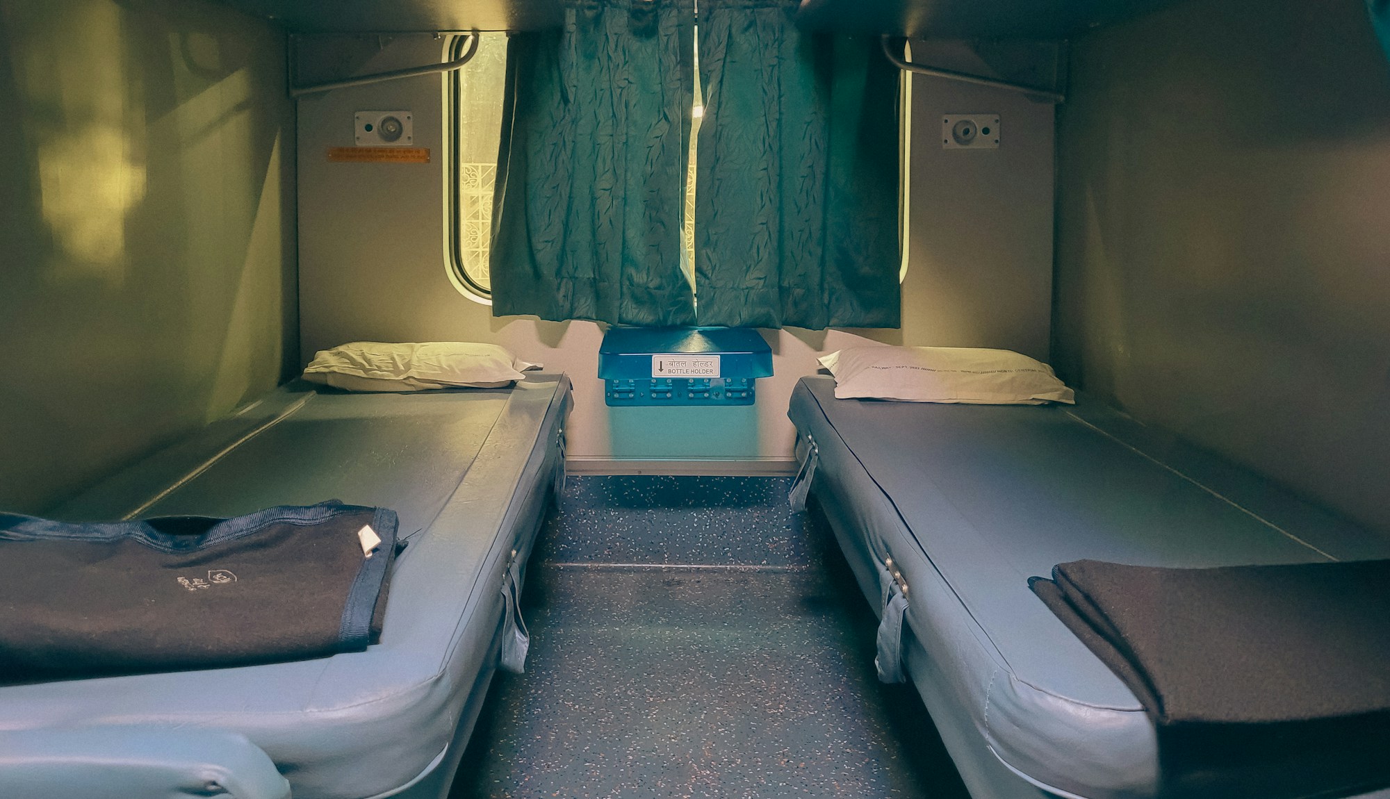 Couchette cabin in a Nightjet train with bedding and soft lighting