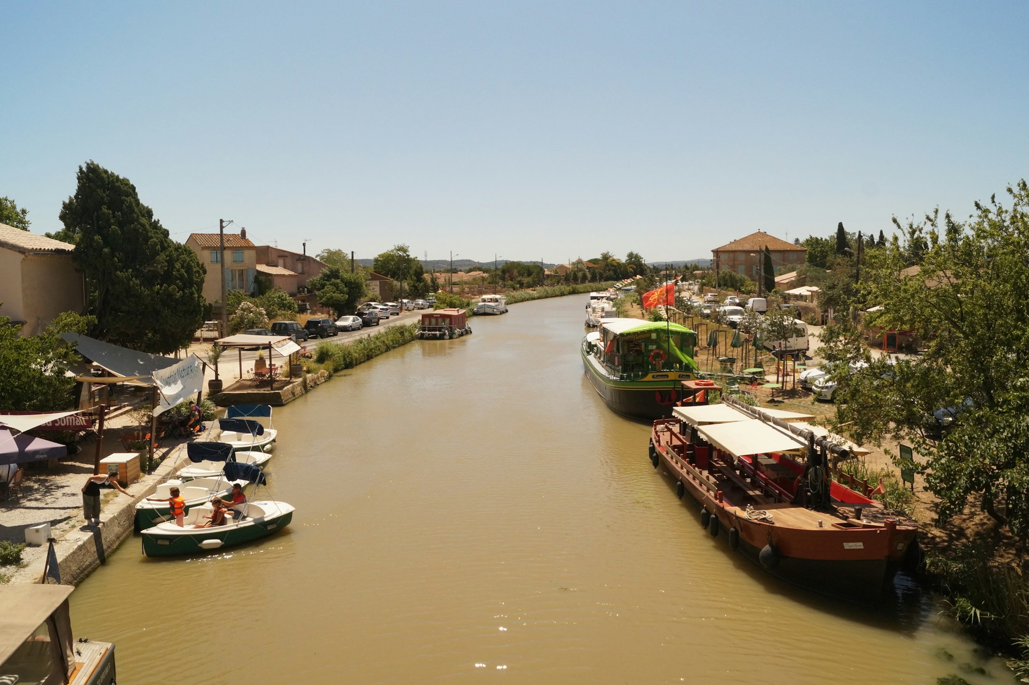 Barge cruising along the Canal du Midi lined with centuries-old plane trees, southern France