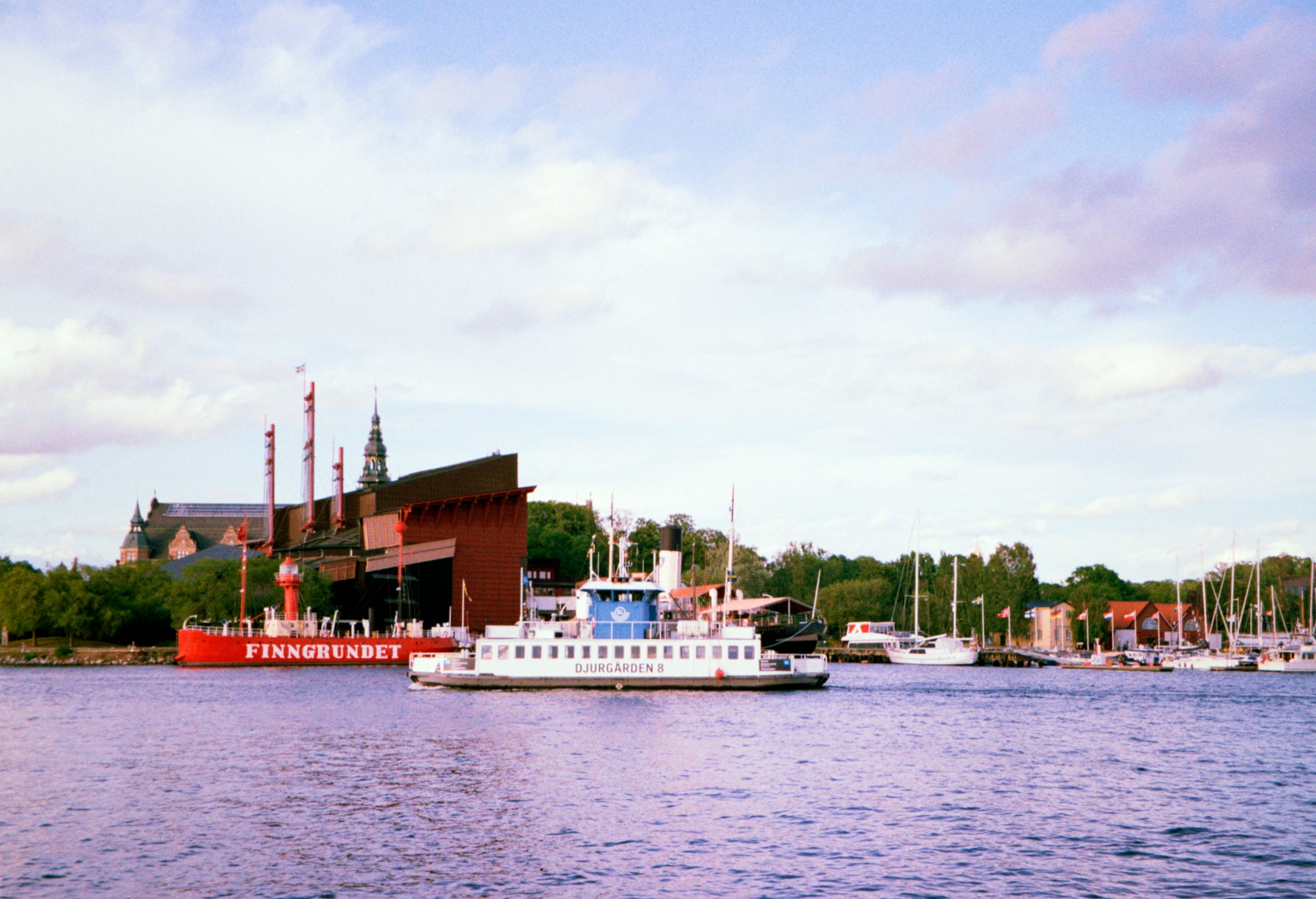 Boat cruising near colorful buildings along a canal in Sweden