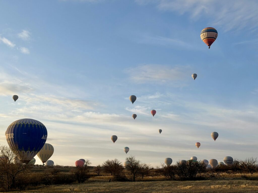 Montgolfières s'élevant au-dessus d'un paysage rocheux au lever du soleil