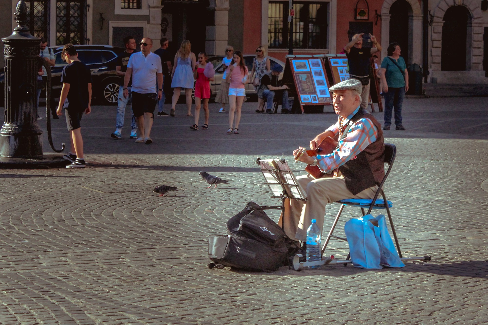 Local musician at Kraków Main Market Square, Poland — cultural budget travel