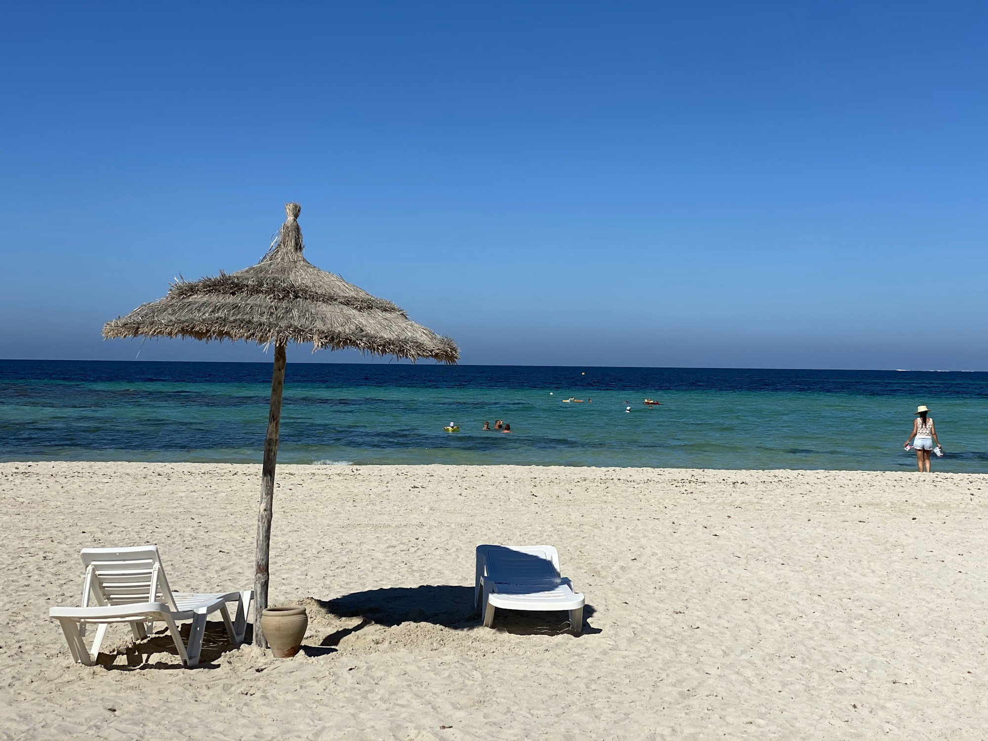Beach umbrellas and sunloungers on a Tunisian beach — budget all-inclusive holidays