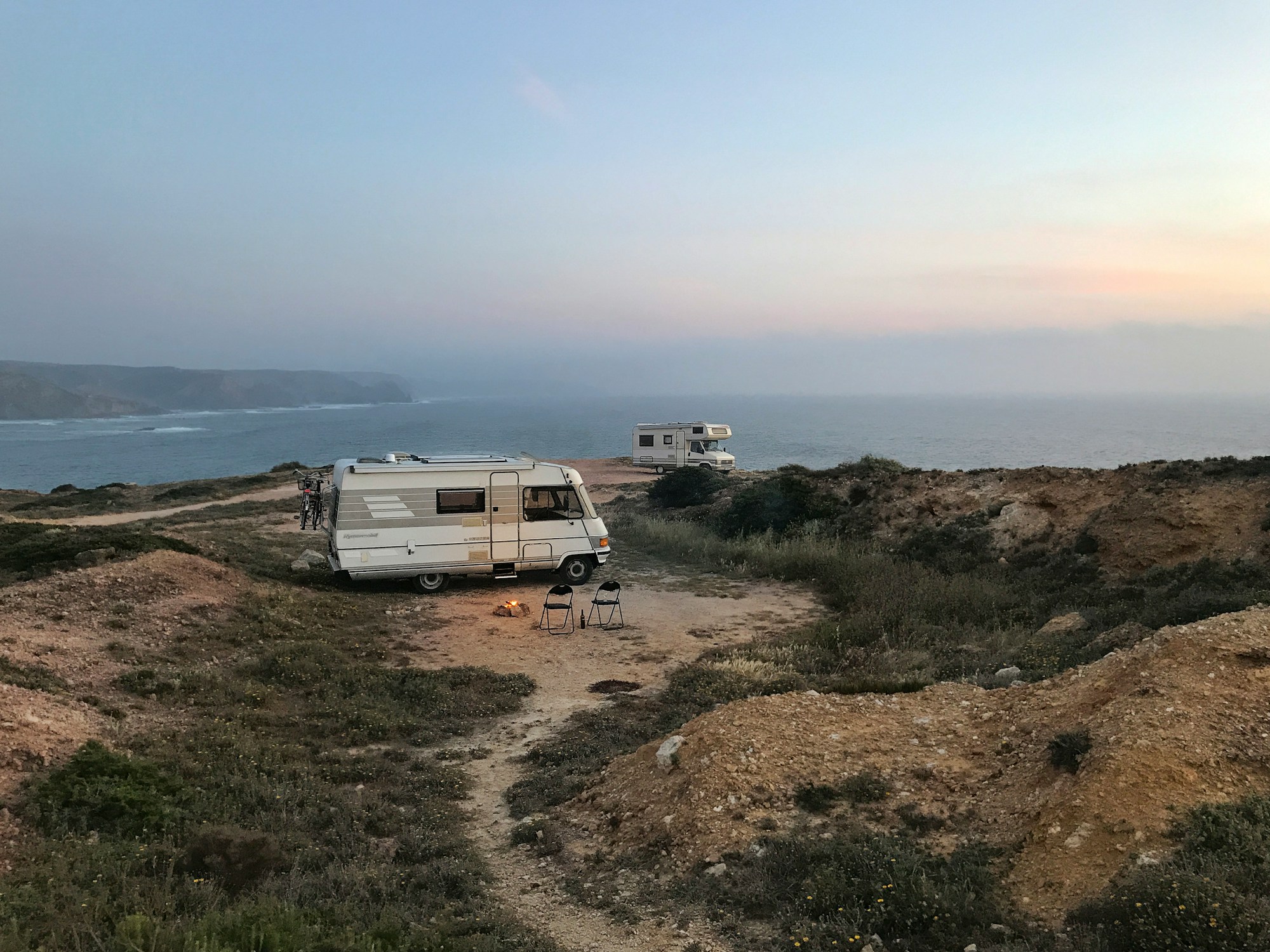 Vans and campers at sunset on the wild Portuguese coast
