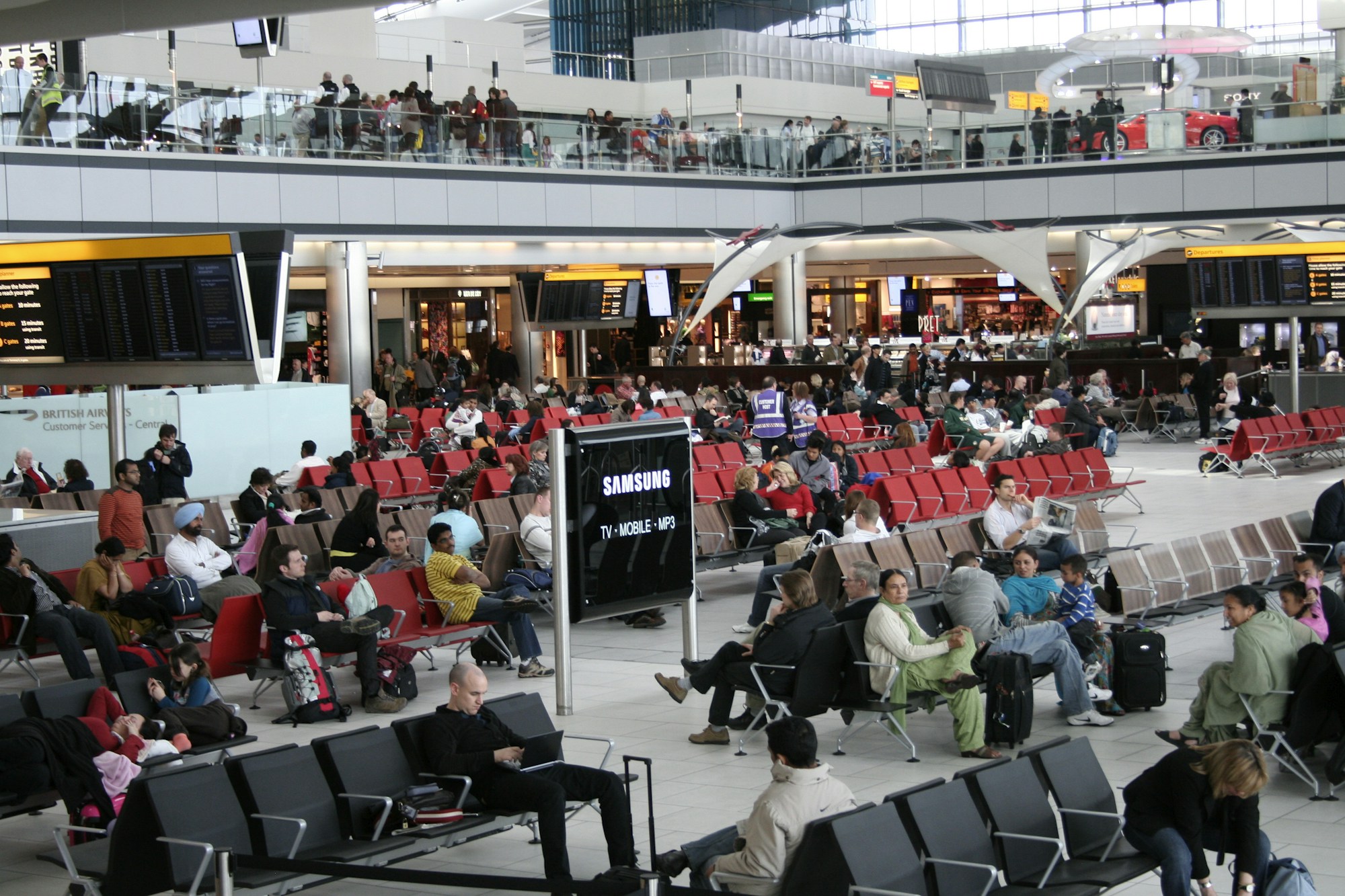 Airport terminal with flight boards — air travel disruptions linked to the Middle East conflict