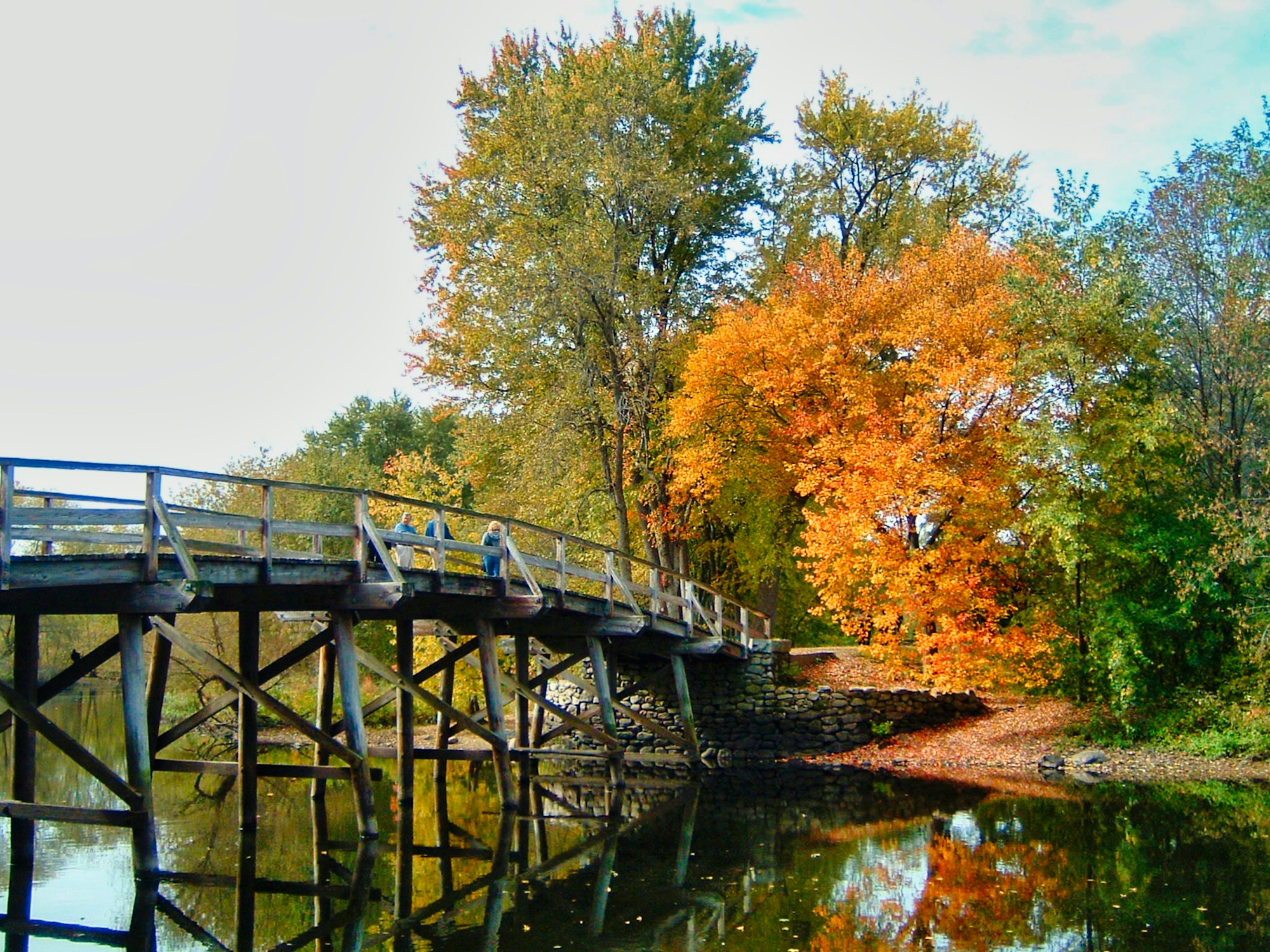 Old North Bridge in Concord, Massachusetts, surrounded by red and orange autumn foliage