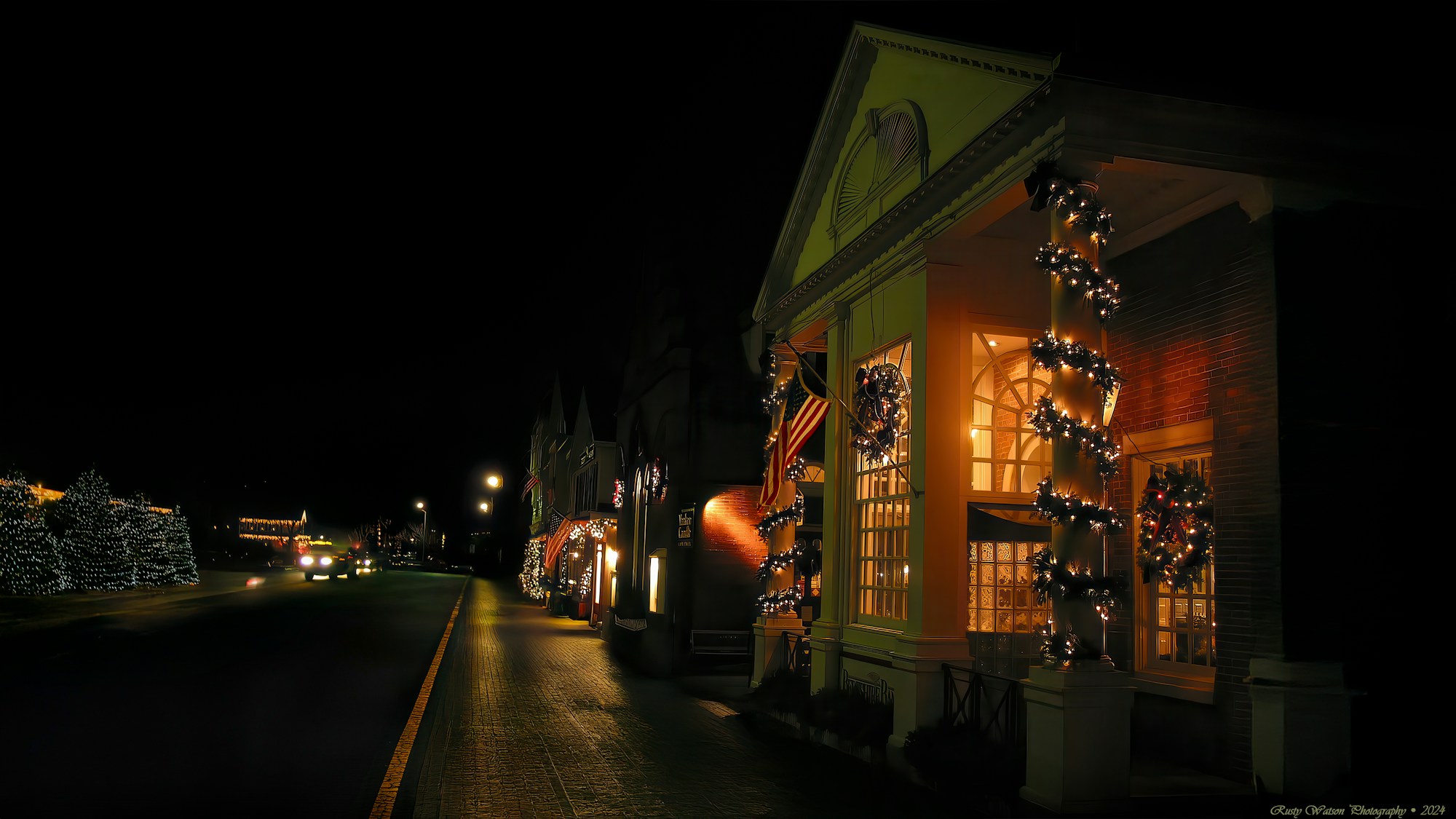 New England street decorated for autumn festivities with pumpkins and lanterns
