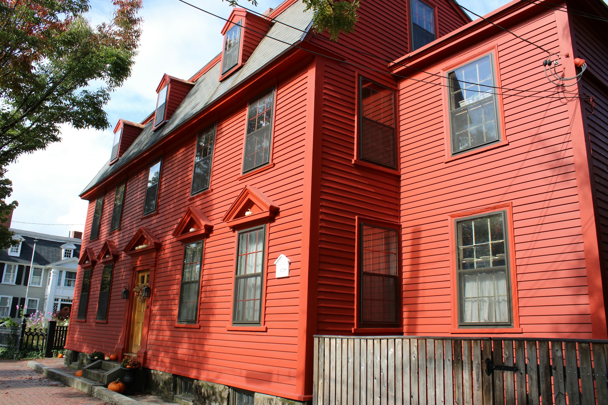 Joseph Neal House, a 17th-century historic home in Salem, Massachusetts, with red wood siding and dormer windows