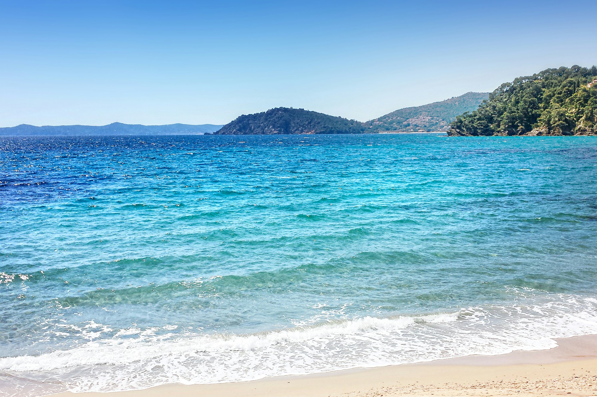Eau turquoise et rivage méditerranéen sur la Côte d'Azur, entre îles et falaises verdoyantes