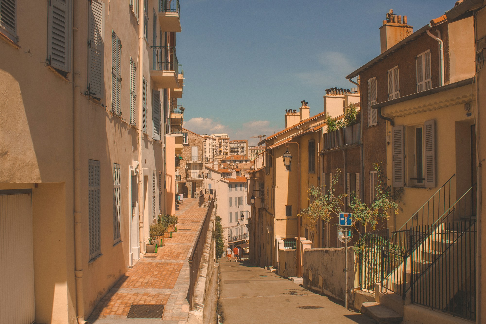White and beige buildings in Cannes under a blue Mediterranean sky, France