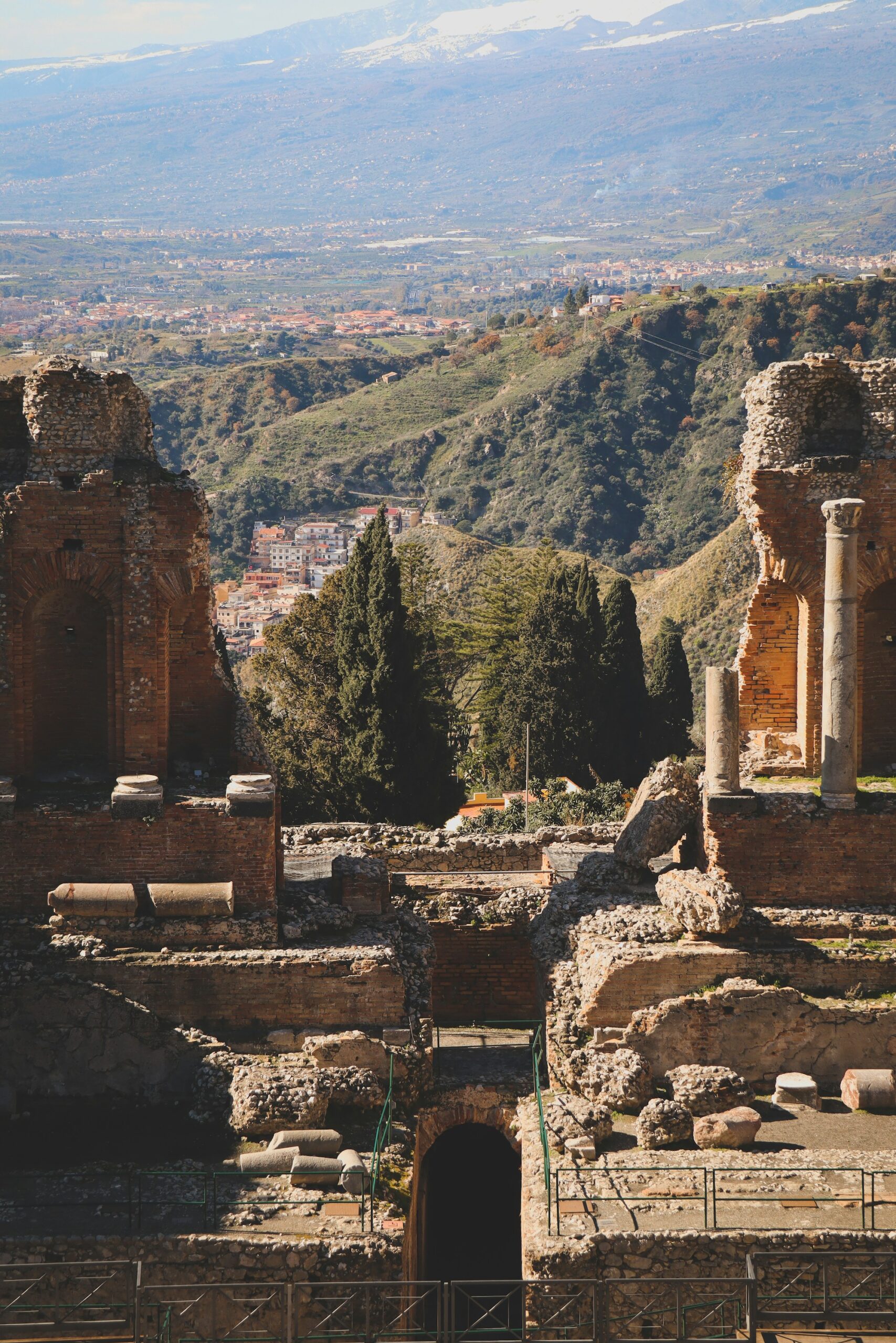 Ancient amphitheatre of Taormina with views of Mount Etna and the sea in Sicily