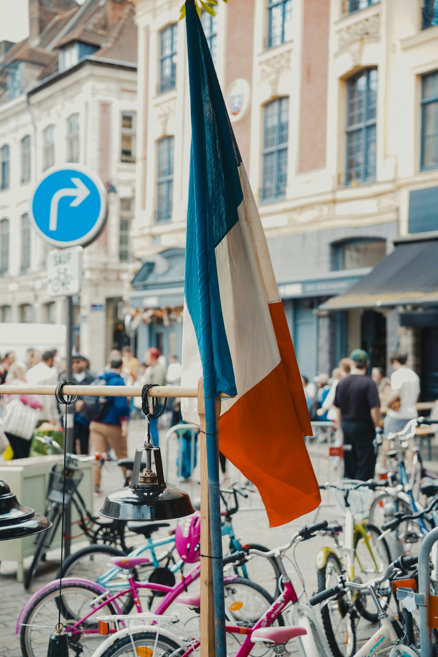 French flag flying alongside bicycles during the Tour de France in Paris