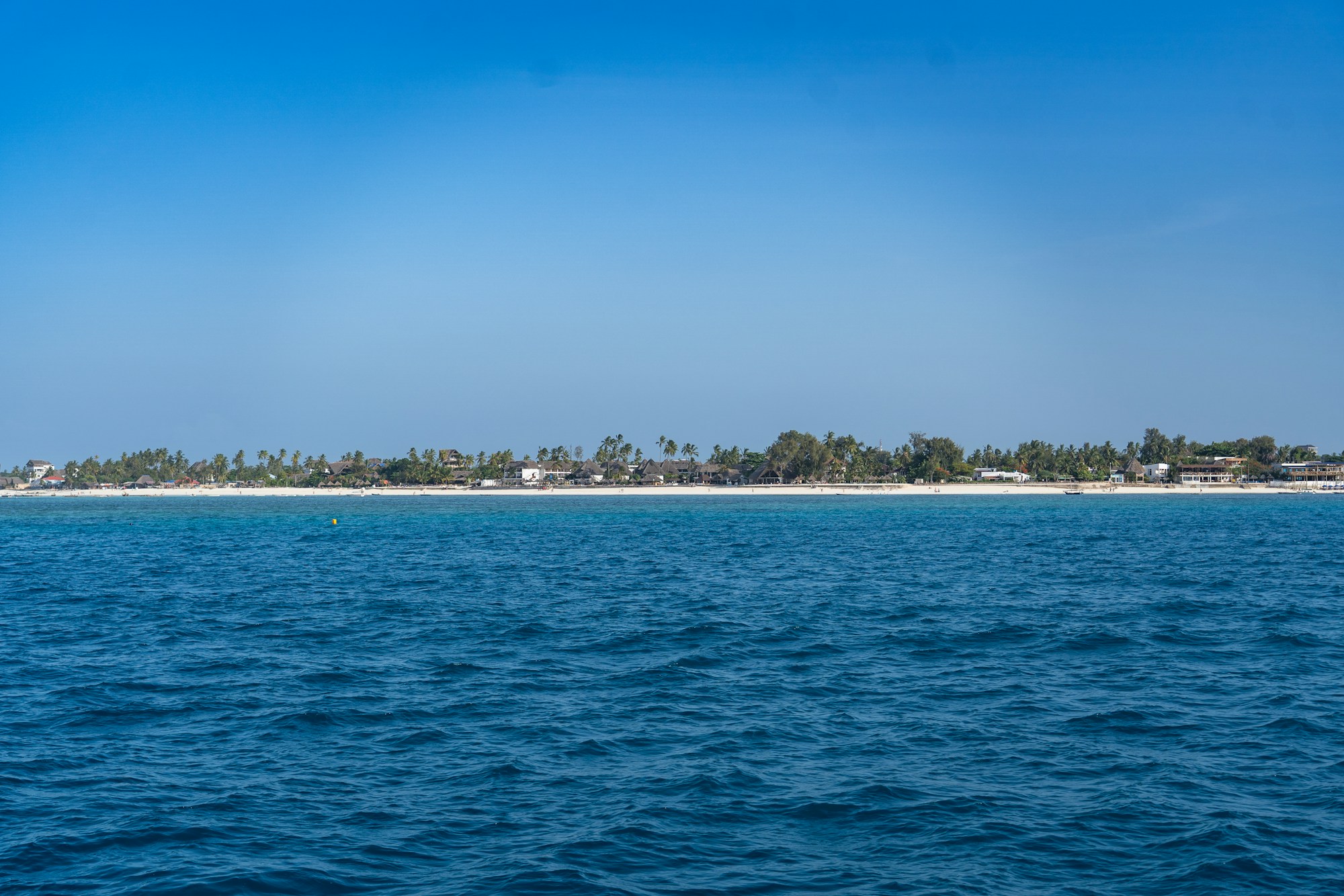 Panoramic view of Zanzibar's coastline with turquoise waters and white sandy beach
