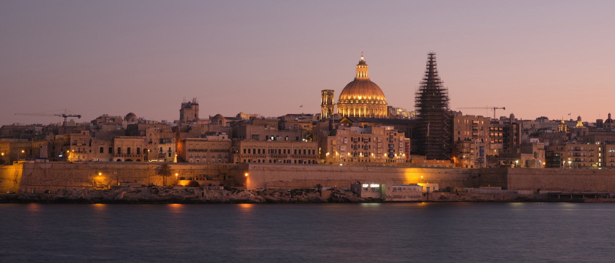 Valletta Malta skyline seen from the sea with its golden fortifications