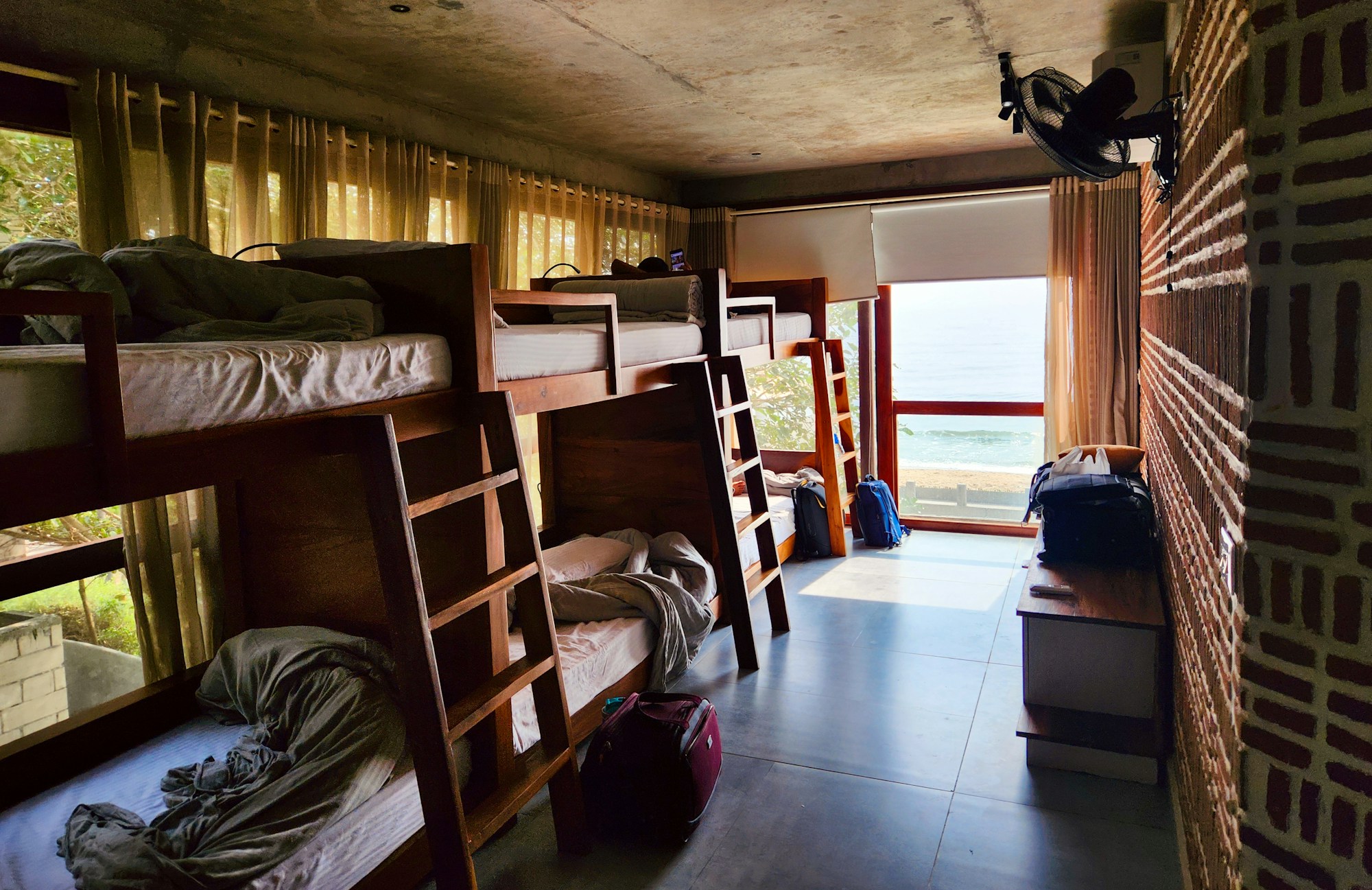 Traveller in a hostel dorm — budget accommodation for the 2026 World Cup