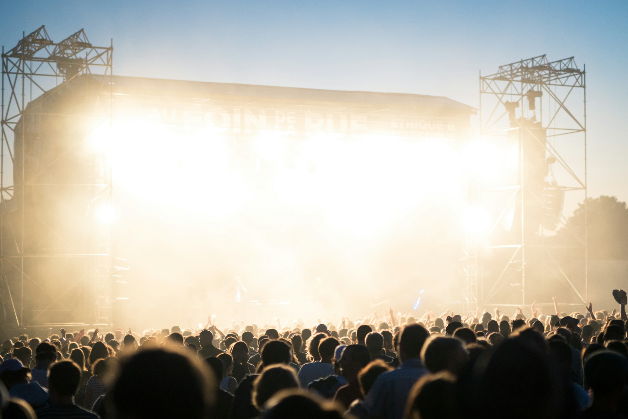 Alternative rock band performing on stage at an outdoor summer festival