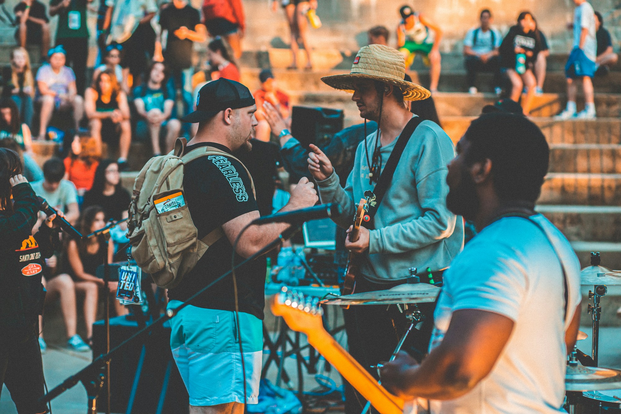 Outdoor night concert with a crowd of festivalgoers under festival spotlights