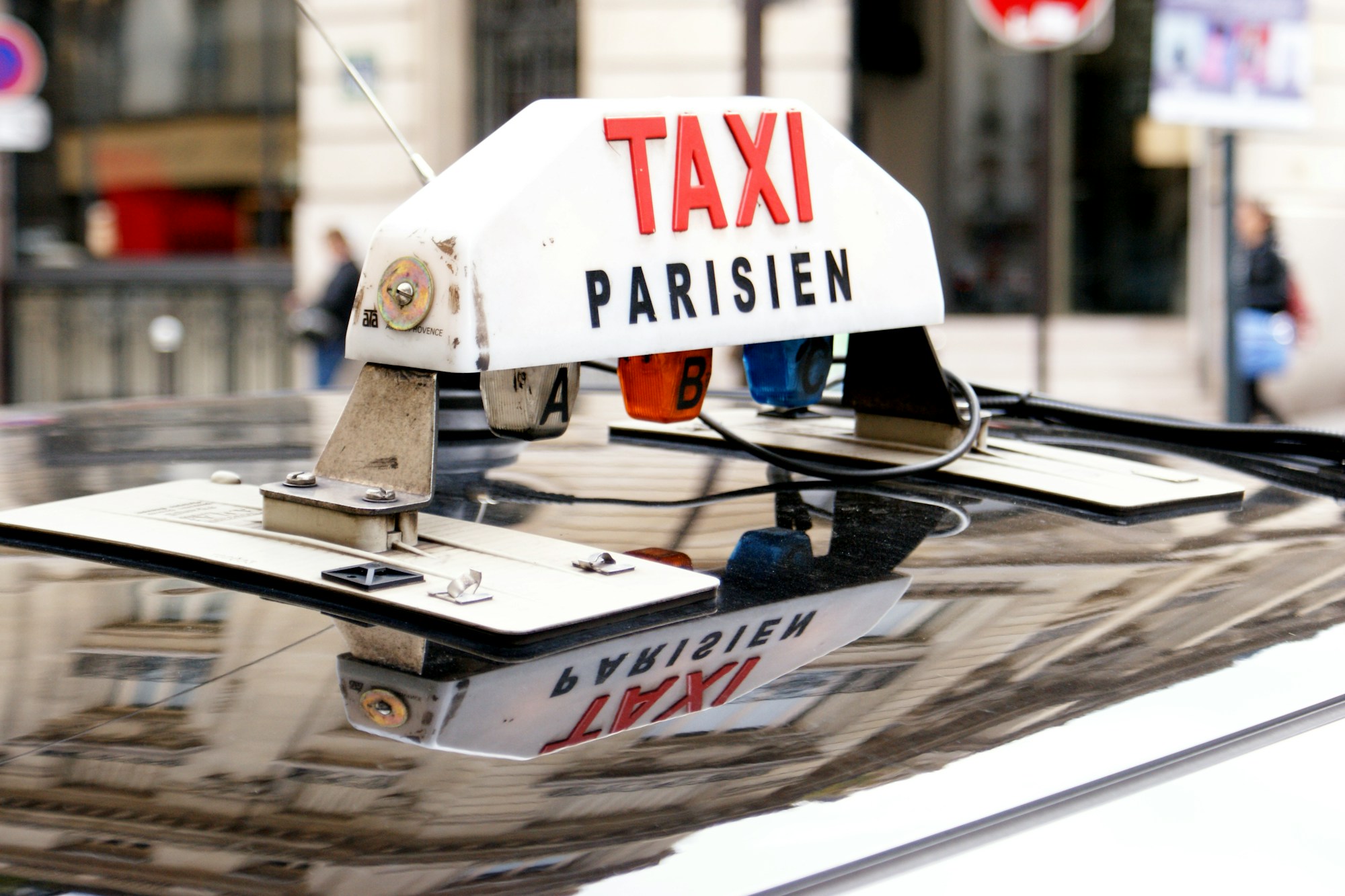 Illuminated Taxi sign in a Paris street