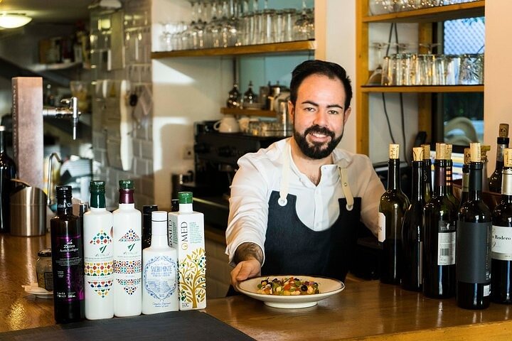 Plates of tapas and glasses of wine on a food tour of Granada's bars