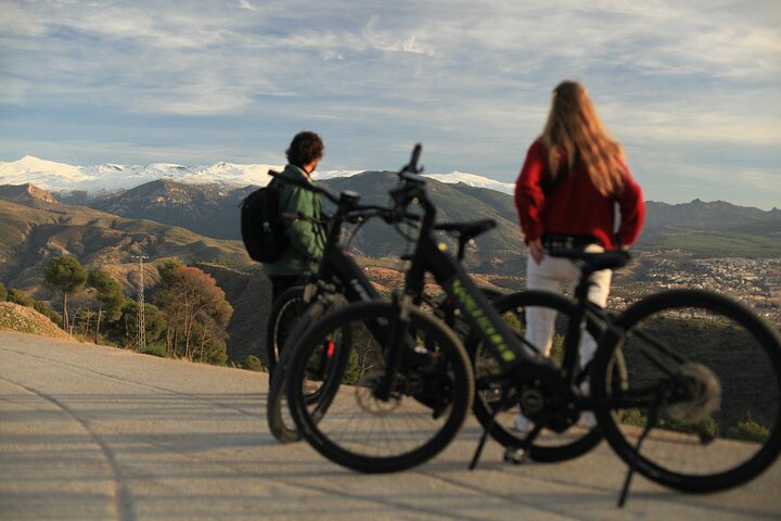 Sunset over the Alhambra walls seen from an electric bike in the hills above Granada