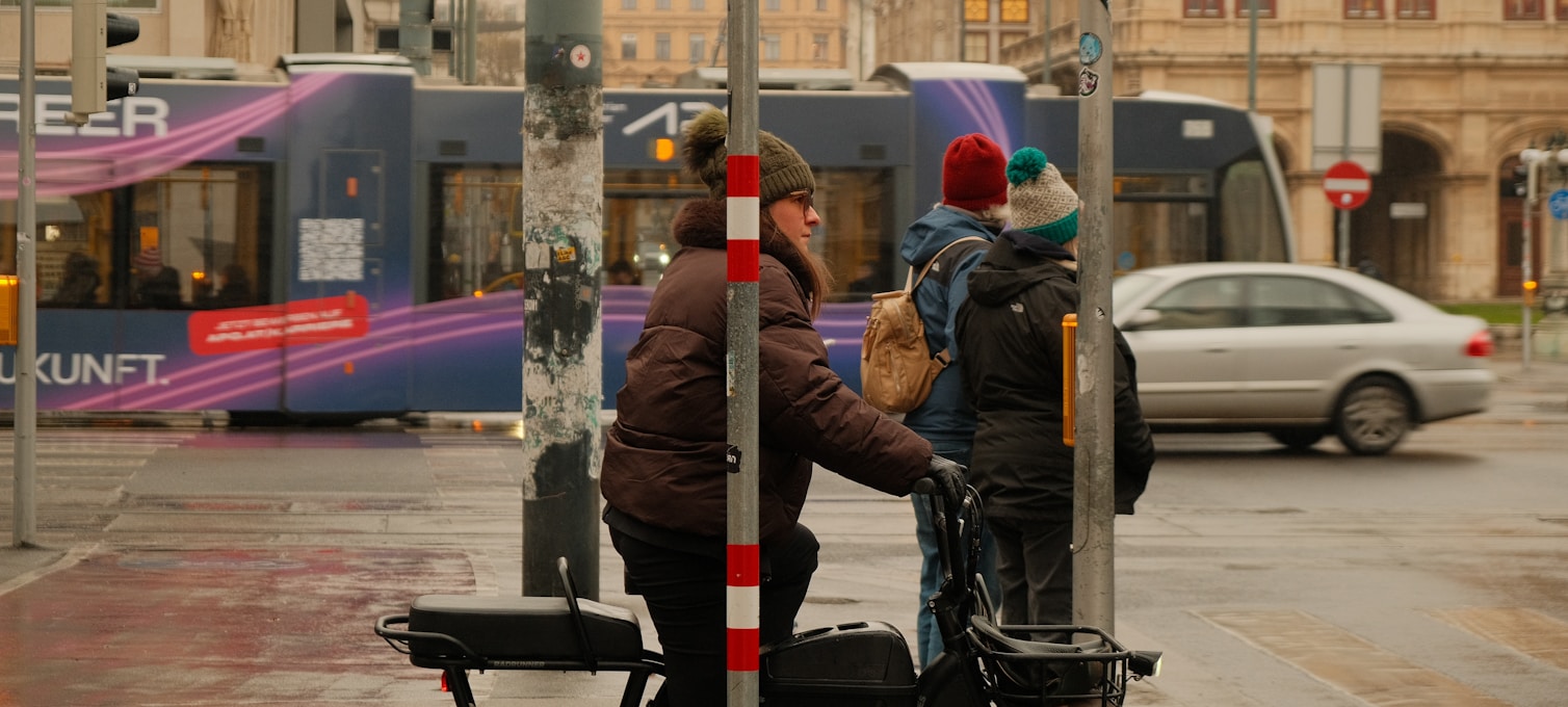 Arrêt de tramway à Vienne en hiver avec passagers et bâtiments historiques
