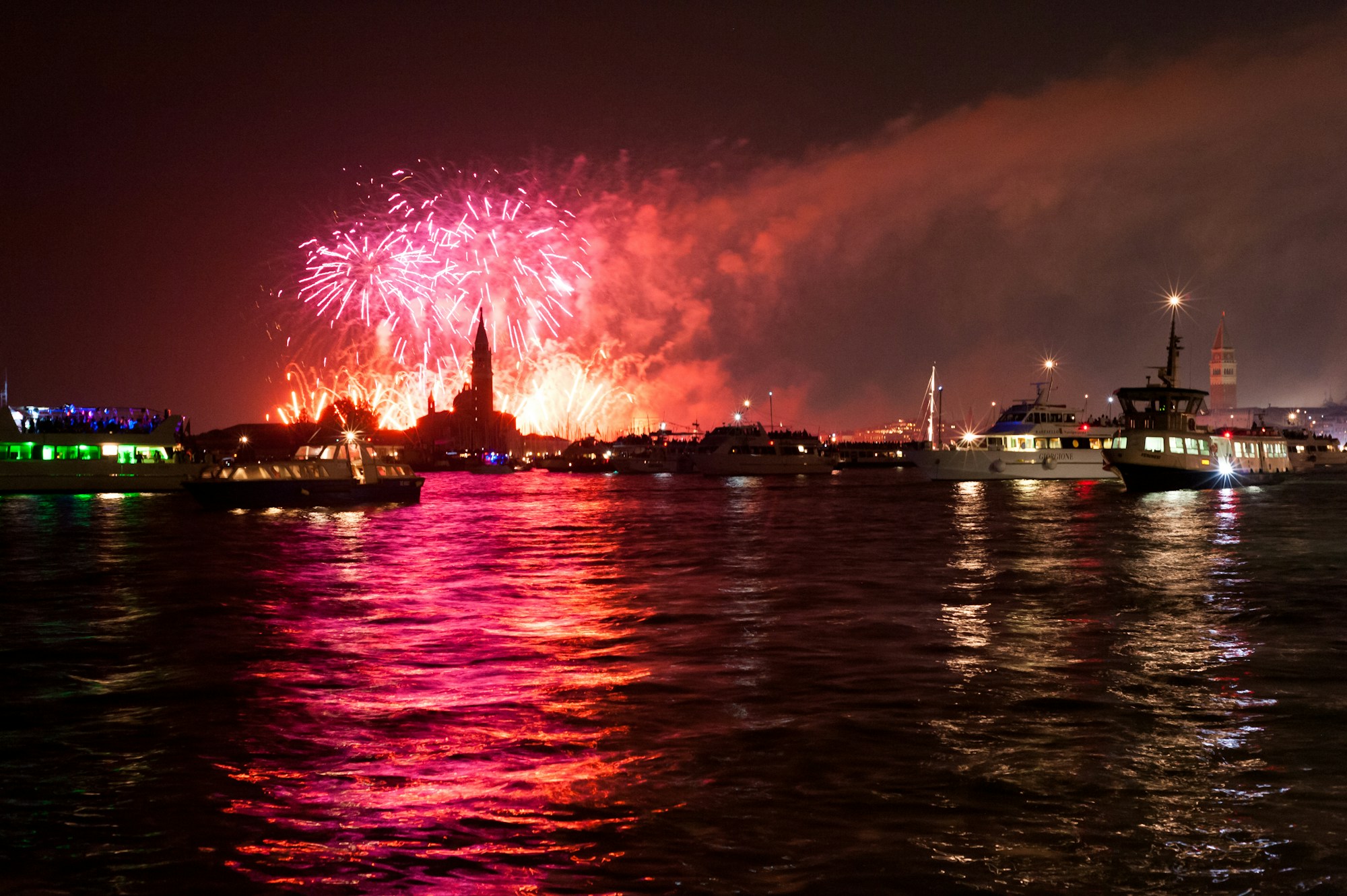 Fireworks from the Festa del Redentore lighting up the night sky above the Venice lagoon