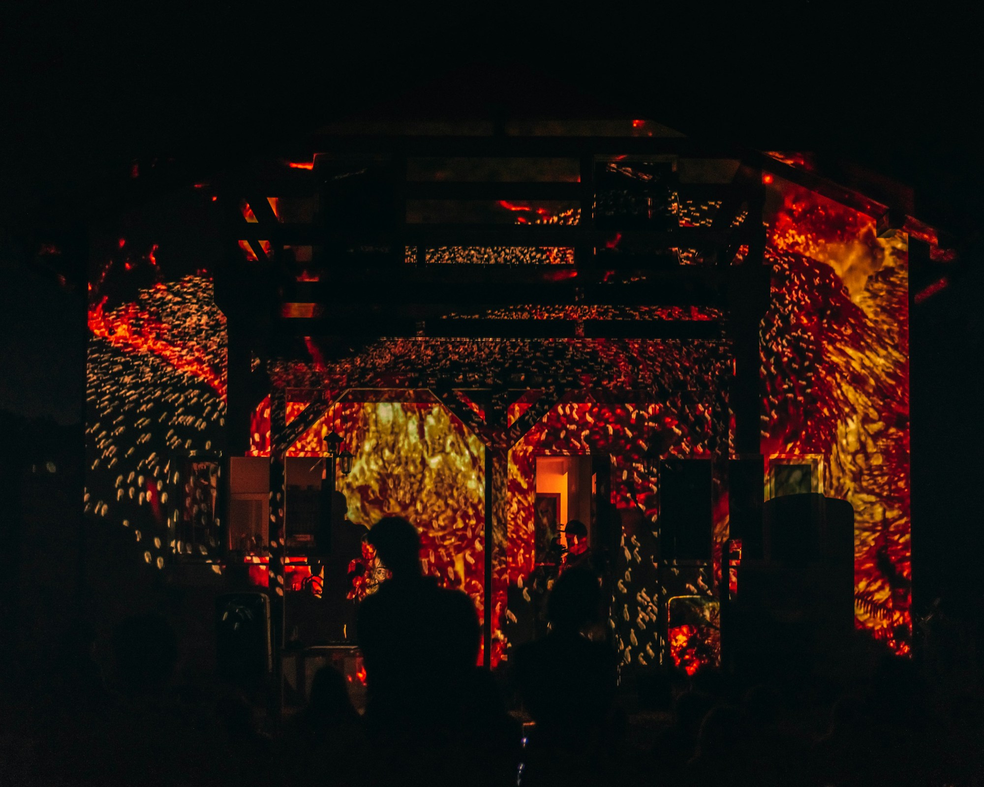 Concert stage with light show and large crowd