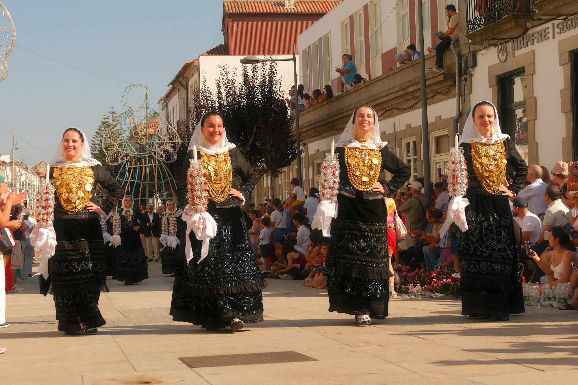 Women in traditional gold costume parading at a romaria in Viana do Castelo