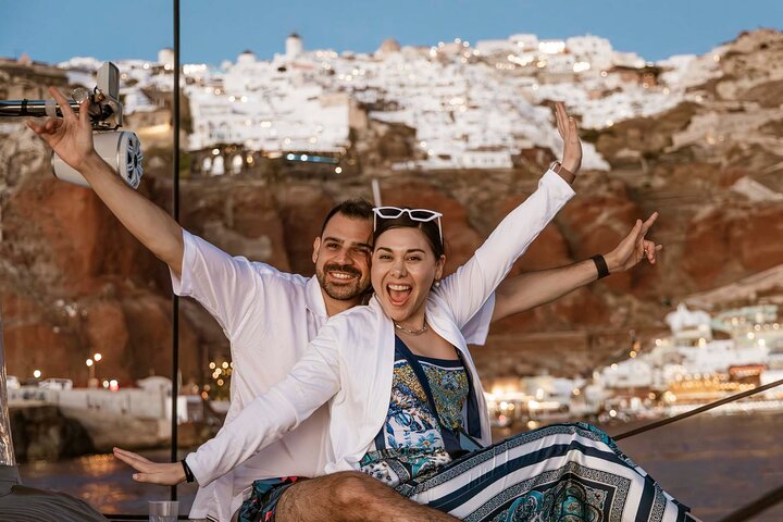 Luxury catamaran along the cliffs of the Santorini caldera