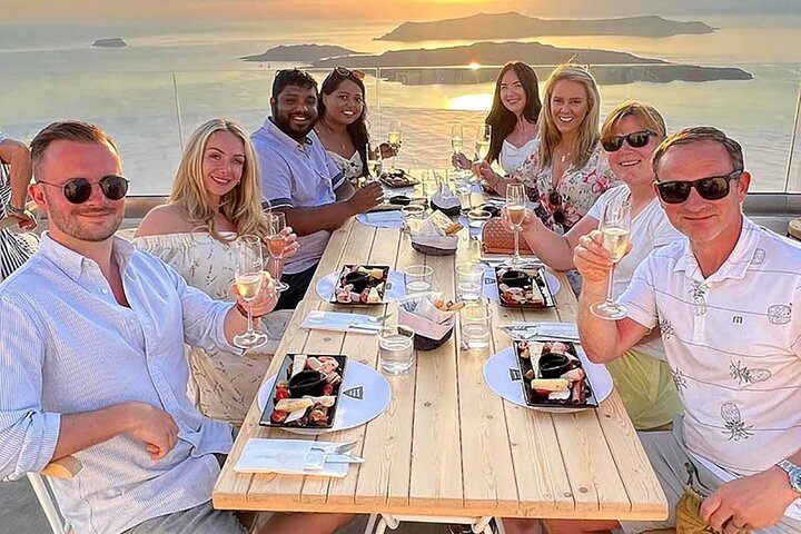 Santorini white wine tasting facing the sunset over the caldera