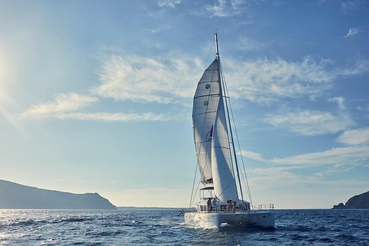 Lagoon 560 catamaran at sunset in Santorini with onboard barbecue