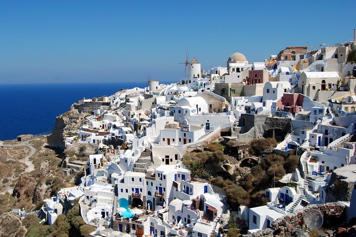 View of Oia village in Santorini at sunset during the small-group excursion