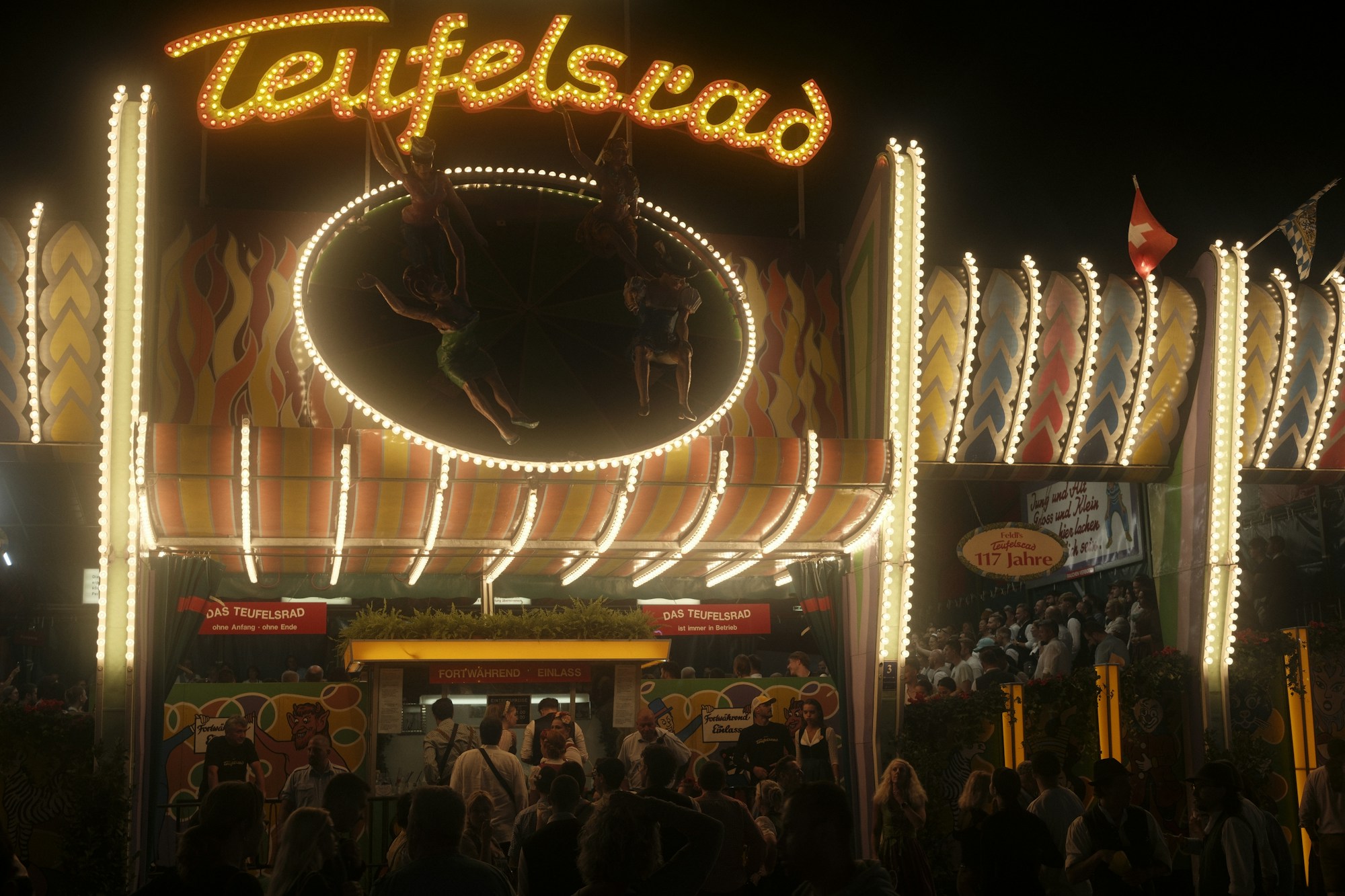 Illuminated fairground rides and beer tents at night at a major German beer festival