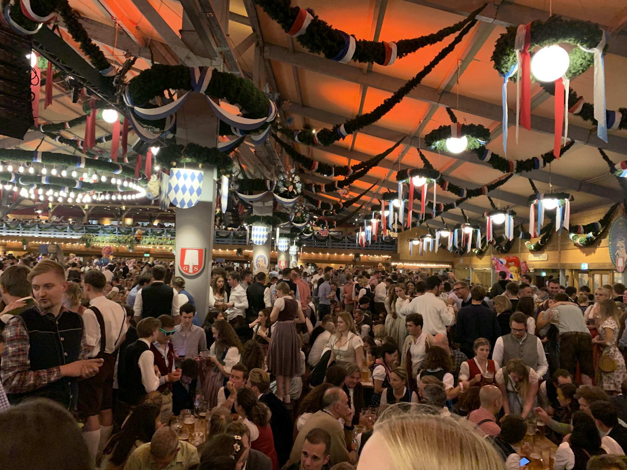 Long tables and a lively atmosphere inside a beer tent at a major German beer festival
