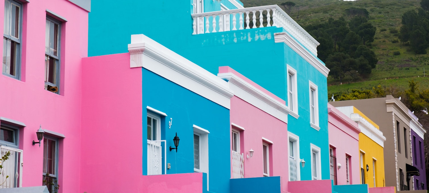 Bunte Häuser im Bo-Kaap-Viertel in Kapstadt, mit dem Tafelberg im Hintergrund