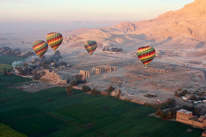 Hot air balloons above the Nile west bank in Luxor at sunrise