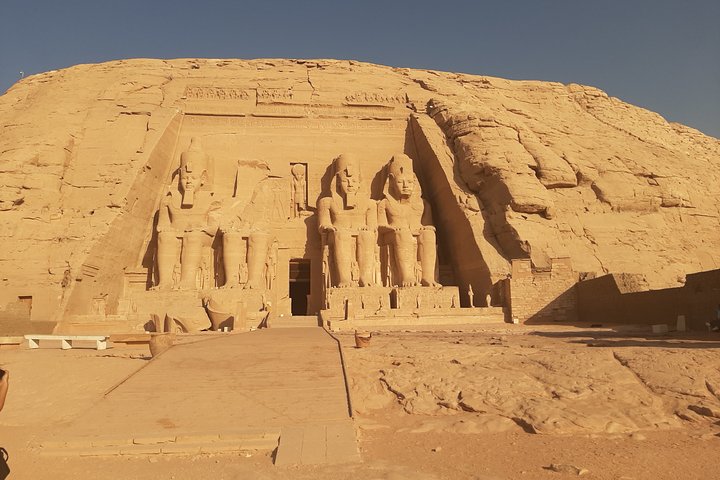 Seated colossi of Abu Simbel temple lit by the morning sun