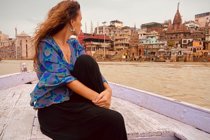 Rowing boat on the Ganges at sunrise in front of the Varanasi ghats