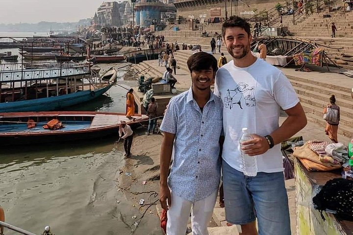 Local guide and visitors in a Varanasi lane