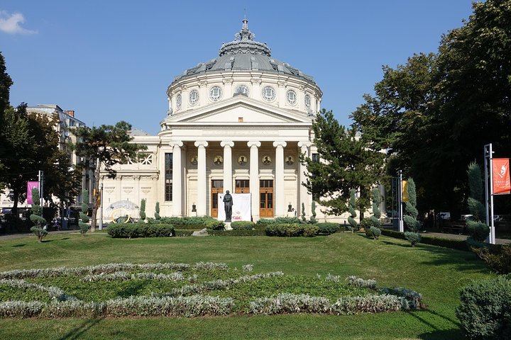 Guida che conduce una visita privata a piedi davanti all'Ateneo Romeno a Bucarest