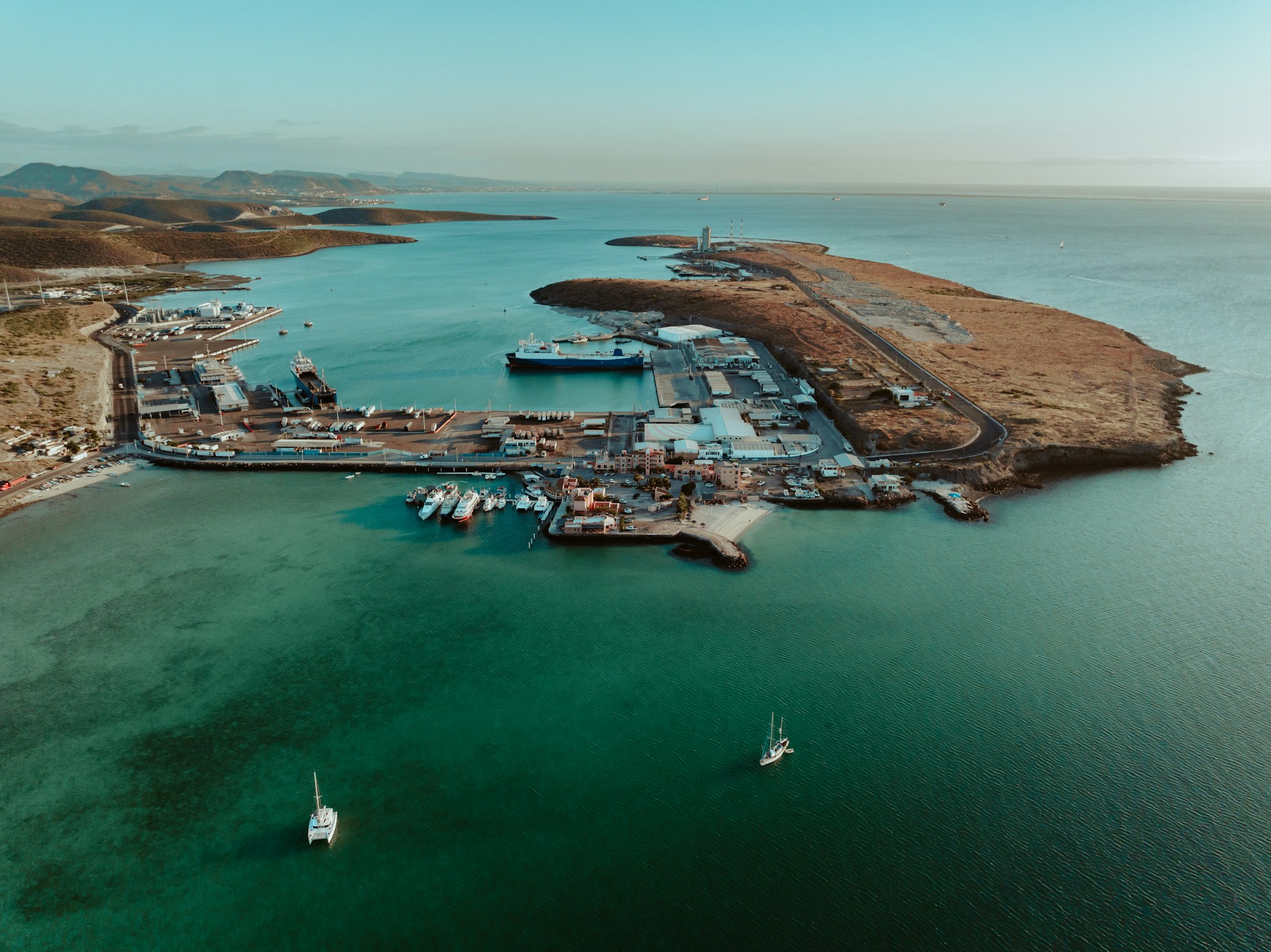 The port of La Paz seen from above, with boats at the dock and a turquoise sea