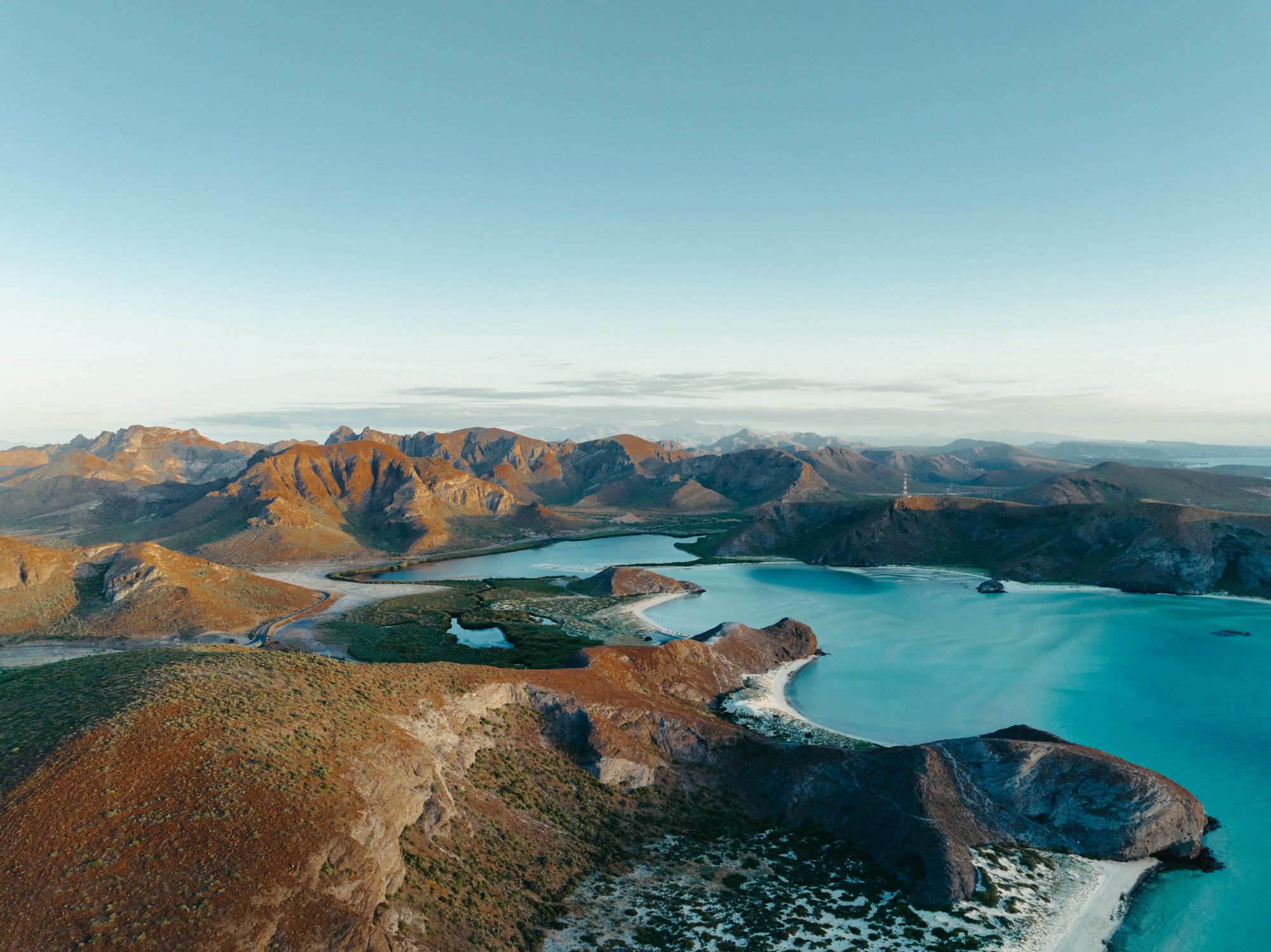Desert bay with turquoise water, surrounded by mountains, in Baja California Sur