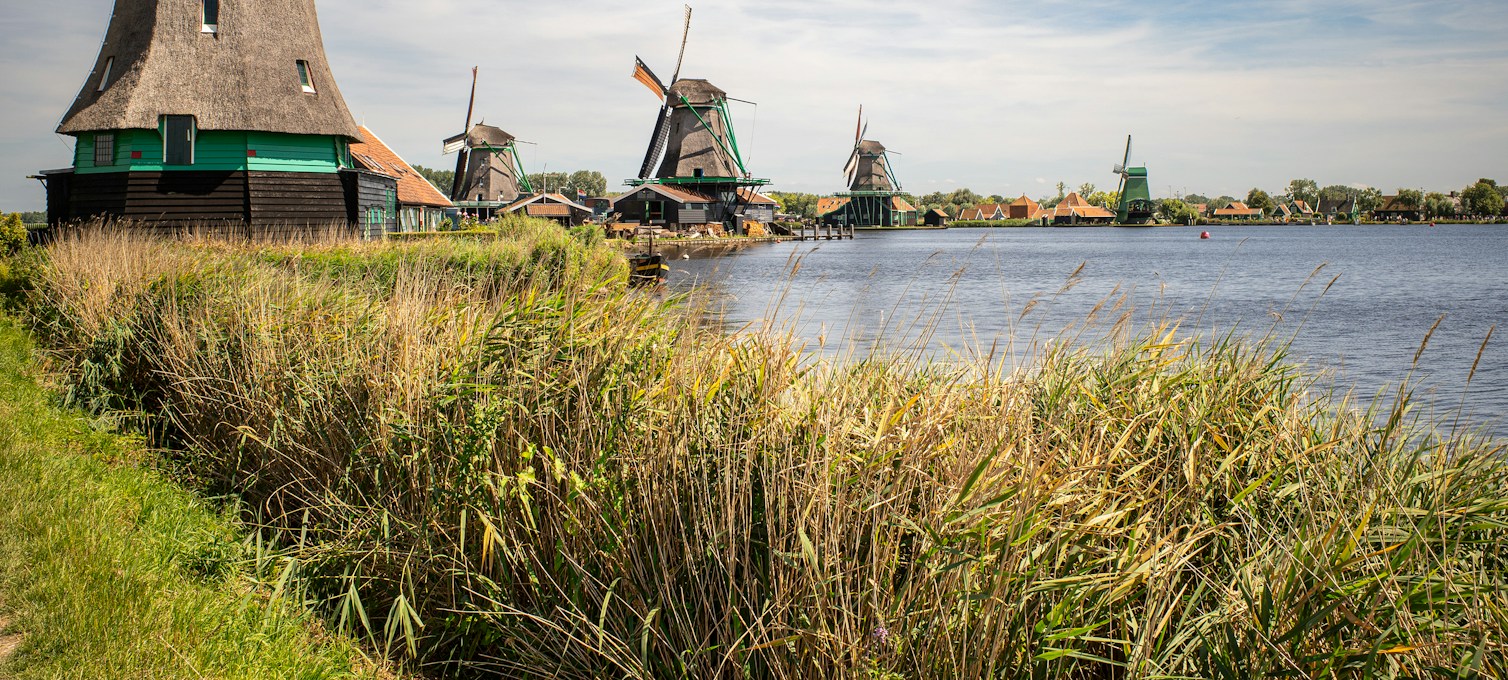 A windmill beside a canal in the Dutch countryside