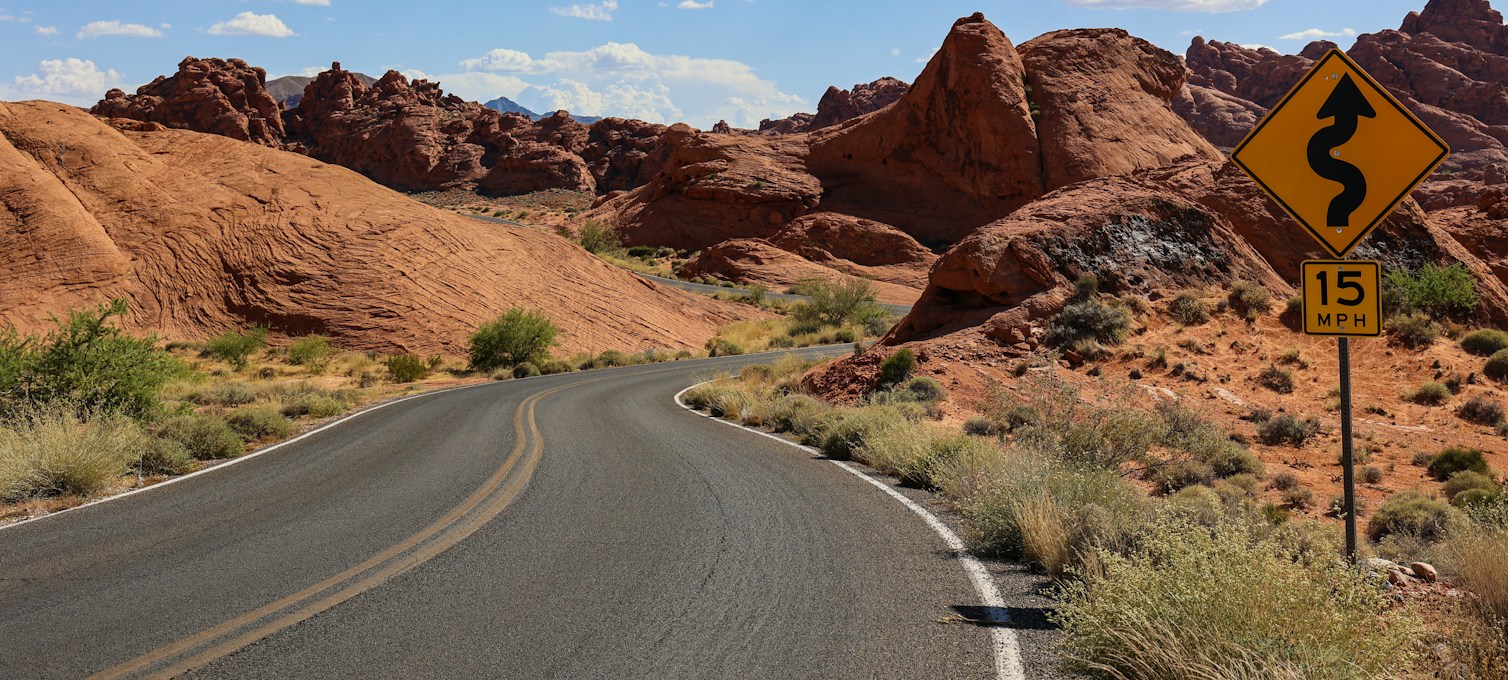 Road winding through red sandstone formations in Valley of Fire State Park, Nevada