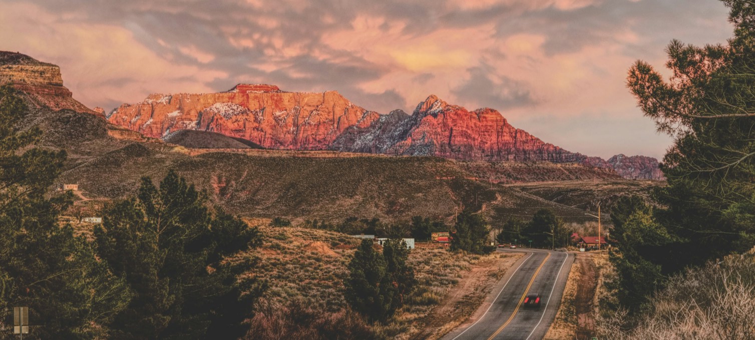 Road leading to the red cliffs of Zion National Park, Utah