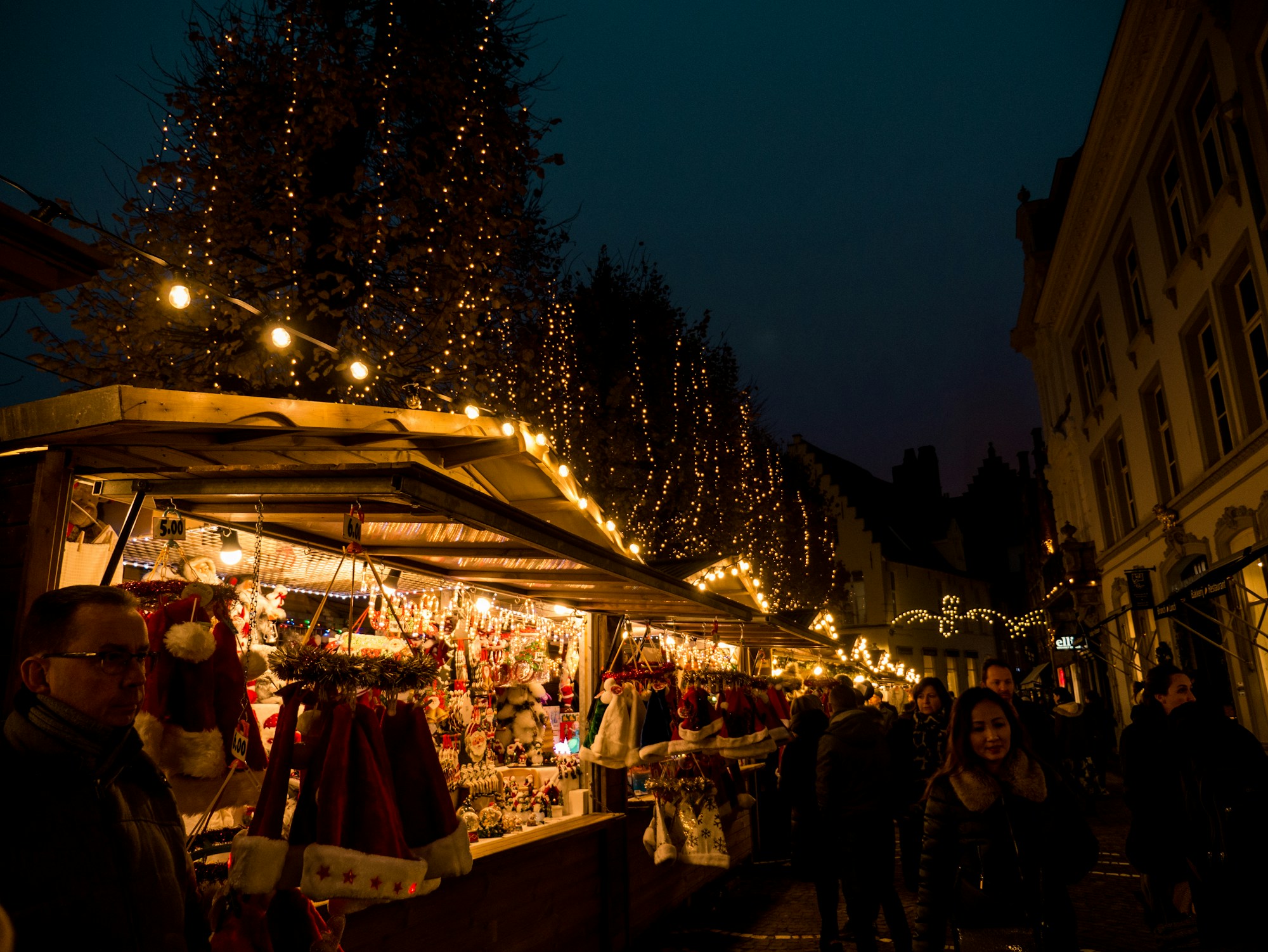 Christmas market at night, stalls lit up in the evening