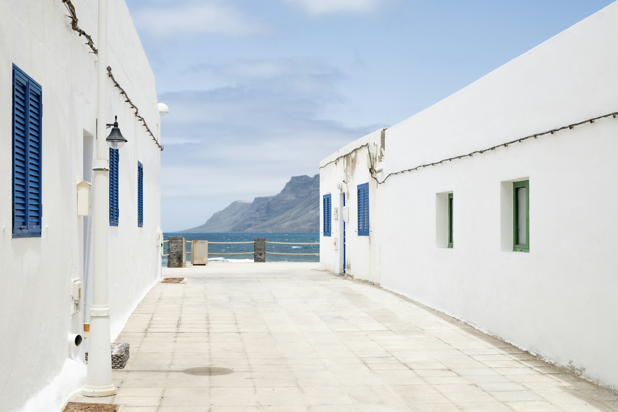 White and blue houses in a Lanzarote village facing the ocean