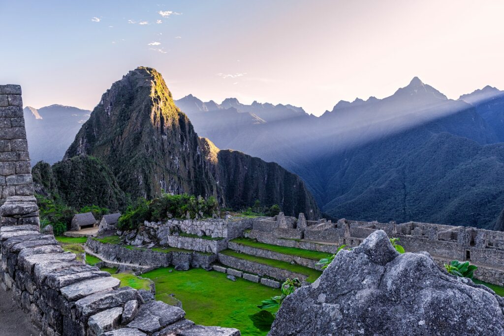 Machu Picchu citadel with Huayna Picchu behind it at sunrise