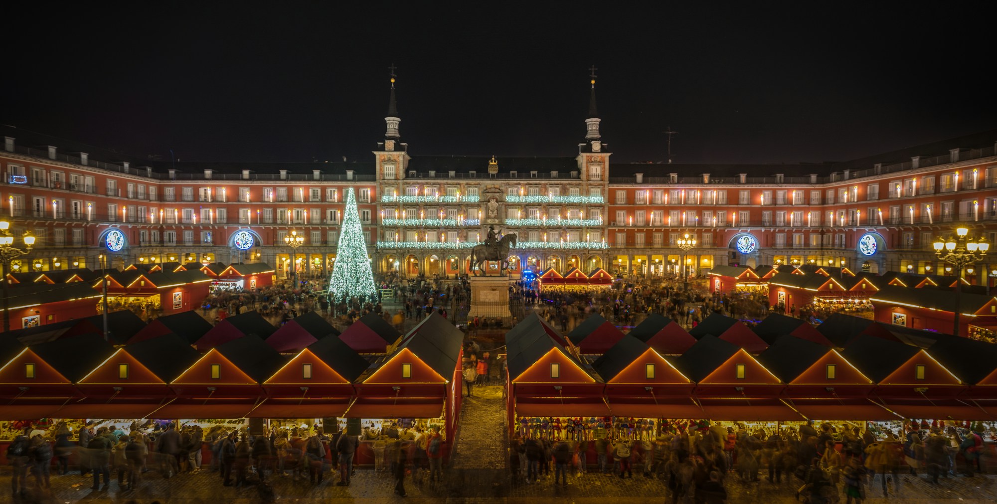 Plaza Mayor in Madrid, lit façades and Christmas market stalls