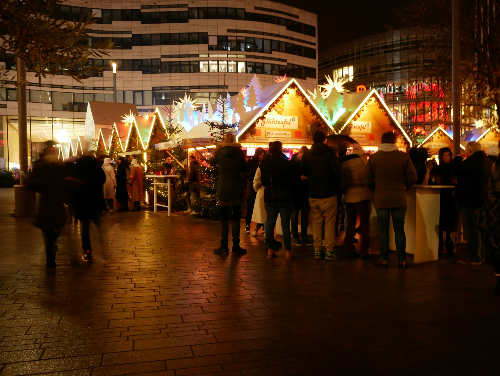 Illuminated chalets at the Düsseldorf Christmas market on the Schadowplatz, in the evening