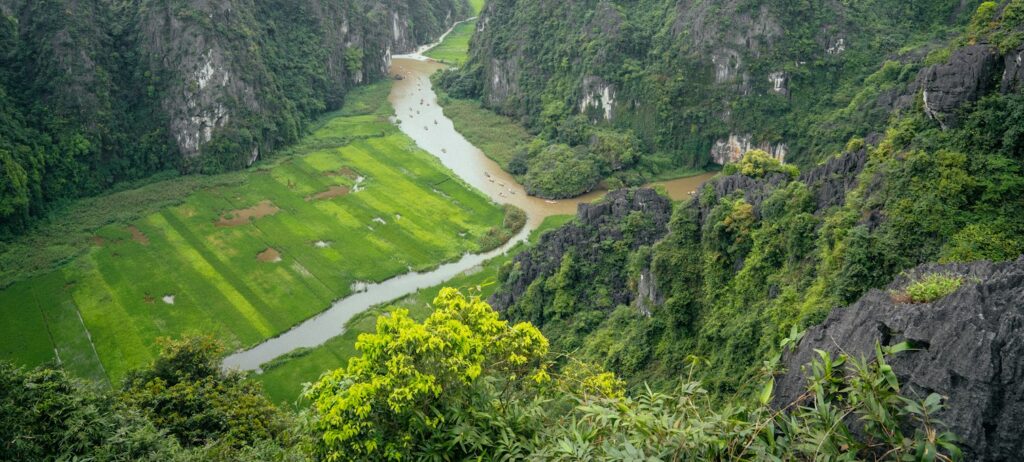 Limestone peaks rising over rice fields and a river in Ninh Binh